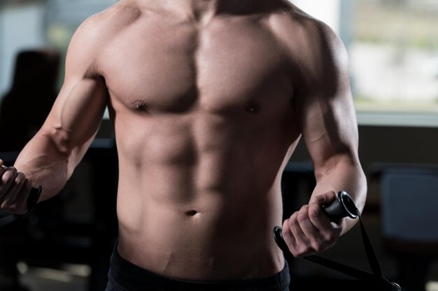 Man Exercising Biceps In The Gym