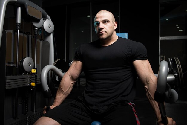 Man Exercising Triceps In The Gym