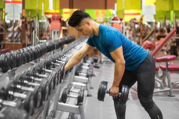 Man Exercising with Arm Weights in Gym