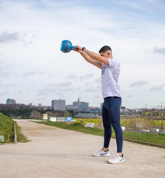 Man exercising with a kettlebell outdoors