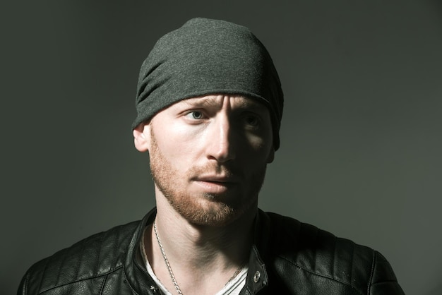 Man face close up. Portrait of adult man of Caucasian appearance isolated on black background.