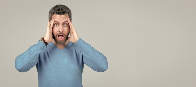 Man face portrait banner with copy space amazed unshaven guy with bristle and moustache tired and stressed mature guy has headache