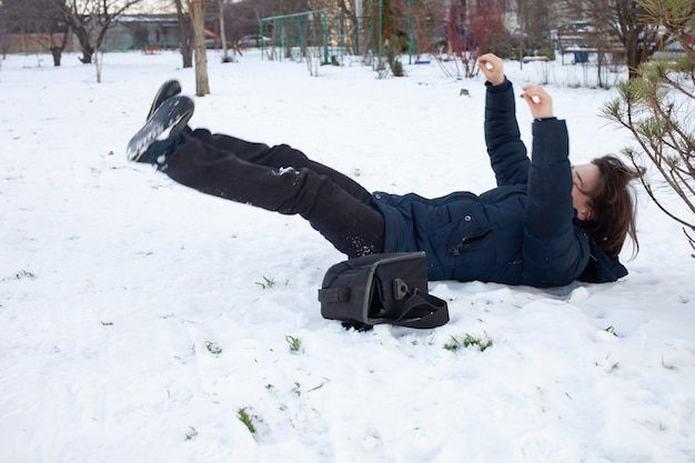 男が雪に落ちる。男は滑ってけがをした