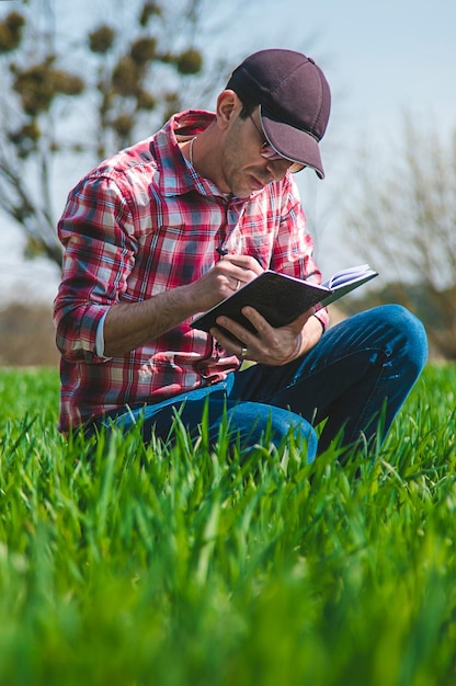 A man farmer checks how wheat grows in the field Selective focus