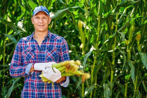 Man farmer with a crop of corn.