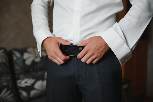 A man fastens buttons on his shirt.