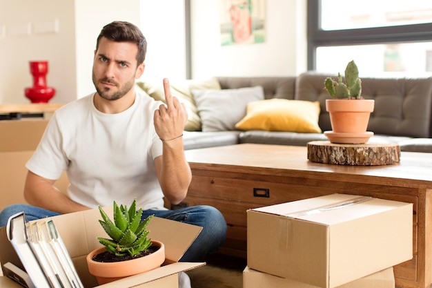 Man feeling angry, annoyed, rebellious and aggressive, flipping the middle finger, fighting back