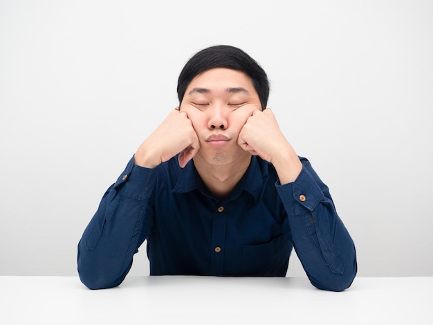 Man feeling bored and sleep at the table