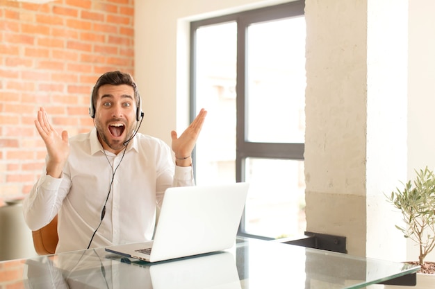 man feeling happy, excited, surprised or shocked, smiling and astonished at something unbelievable