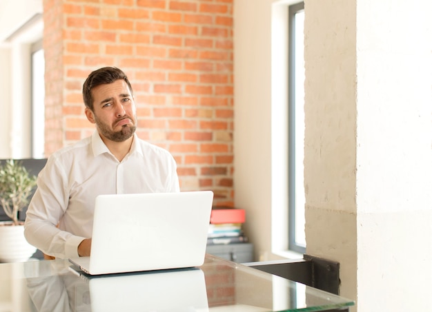 man feeling sad and whiney with an unhappy look, crying with a negative and frustrated attitude