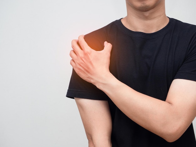 Man feels pain his shoulder isolated studio shot