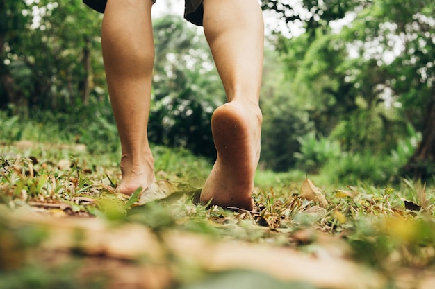 Man feet walking on the grass in the mountain