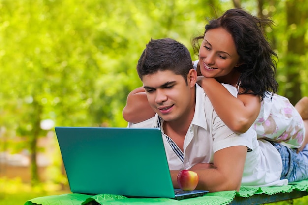 Man and female using laptop