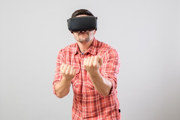 Man in fighter stand with virtual reality glasses