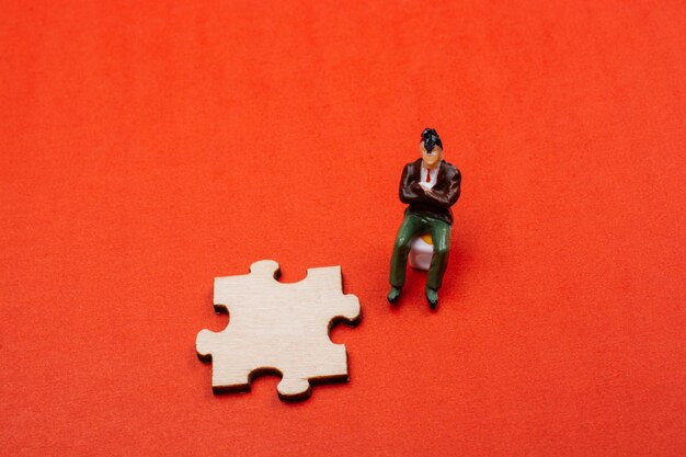 Man figurine and Puzzle piece as business cooperation concept