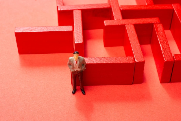 Man figurine and Red wooden labyrinth maze elevated high angle view