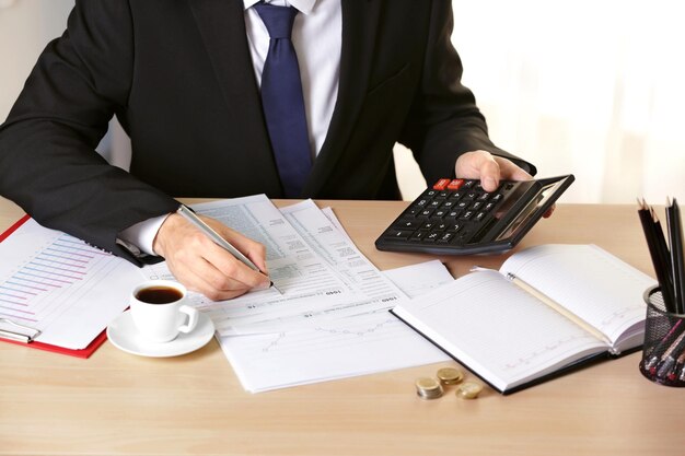 Man filling individual income tax return form closeup