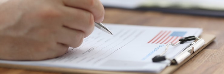 Photo man filling out documents for us visa closeup