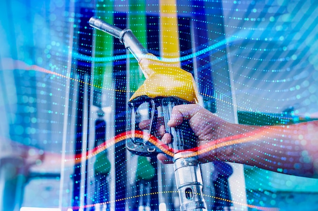 A man fills up a car at a gas station on technological background Graph of rising prices for gasoline and fuel