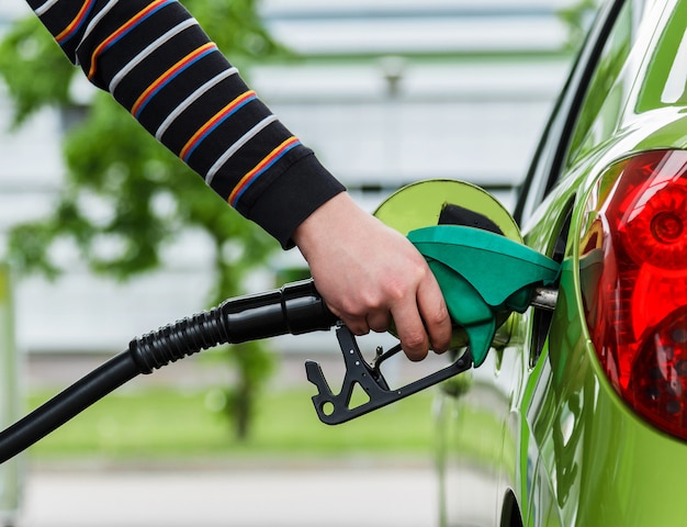 Man fills up his car with a gasoline