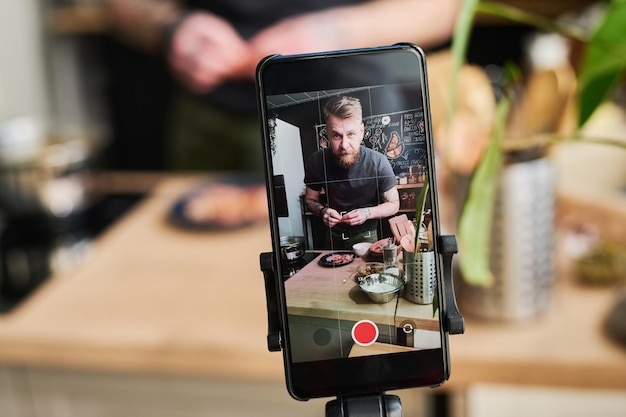 Man Filming Content On Smartphone