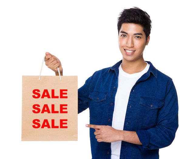 Photo man finger point to shopping bag for showing three sale words