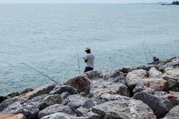 Man fishing on sea shore