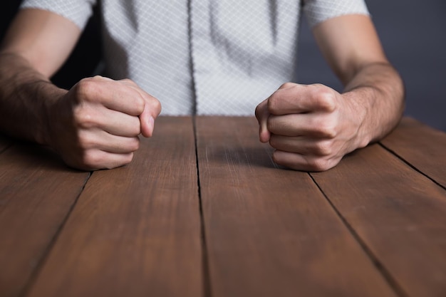 Man fists on table