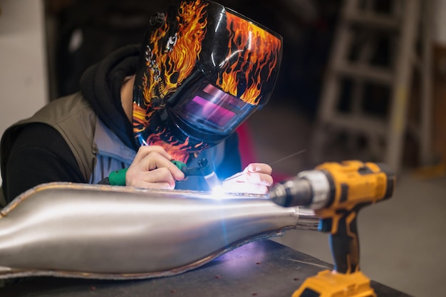 Man fixing a motorcycle in a modern workshop