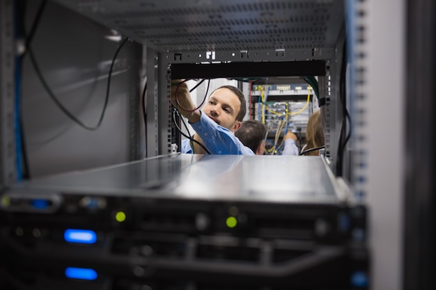 Man fixing wires at server