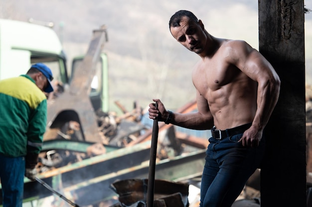 Man Flexing Muscles With Shovel