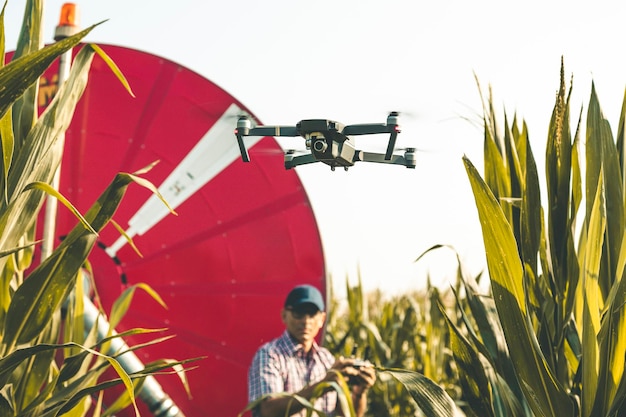Man flying drone against clear sky in farm