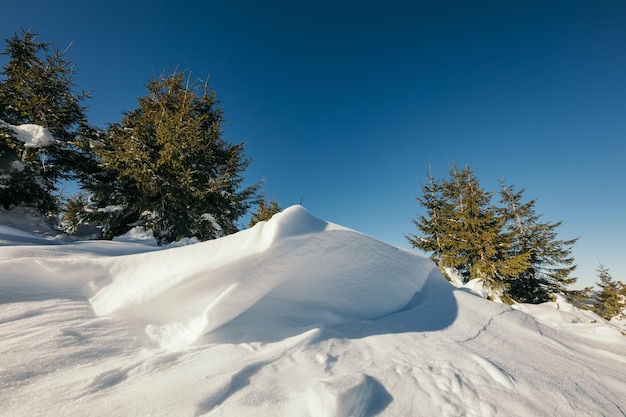 A man flying through the air on a snow covered slope