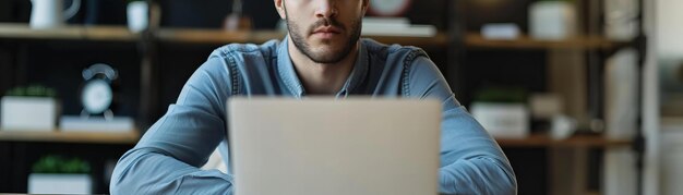 Man focused on screen in blurred office setting Concentration and business workflow concept