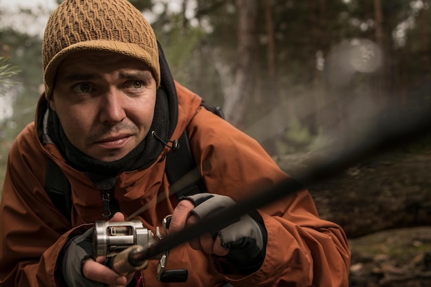 A man in a forest with a gun