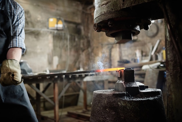 Man forging the iron in the workshop