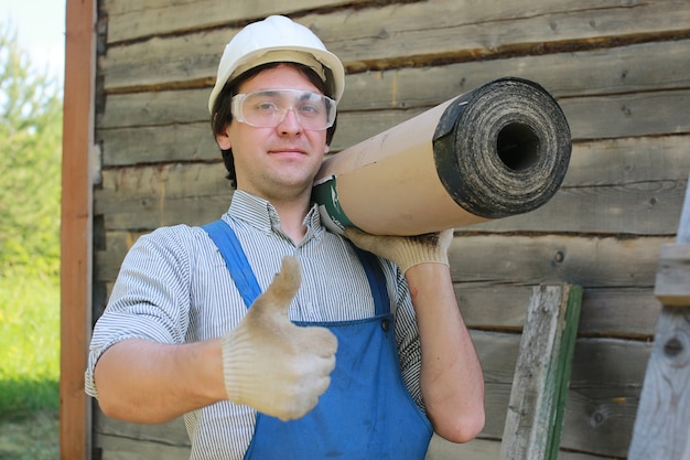 A man in the form of a builder repairs a house