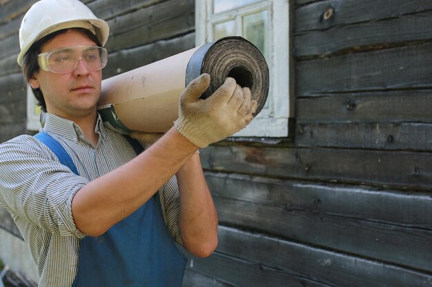 A man in the form of a builder repairs a house