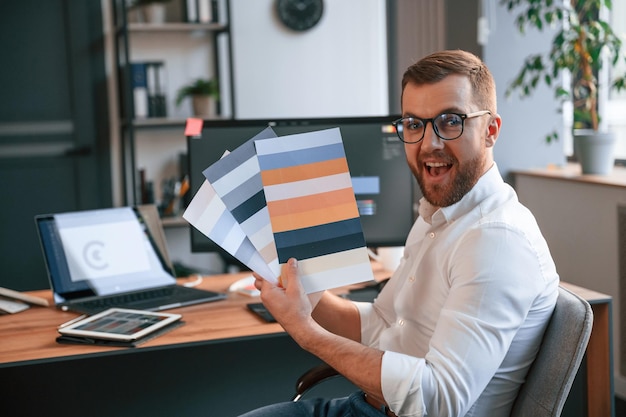 Man in formal clothes is working in the modern office Using computer