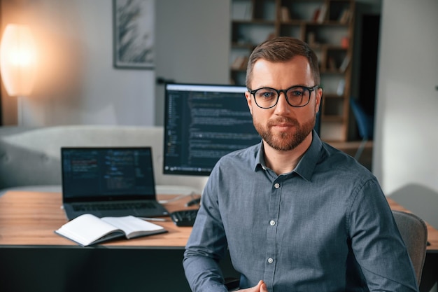 Man in formal clothes is working in the modern office Using computer