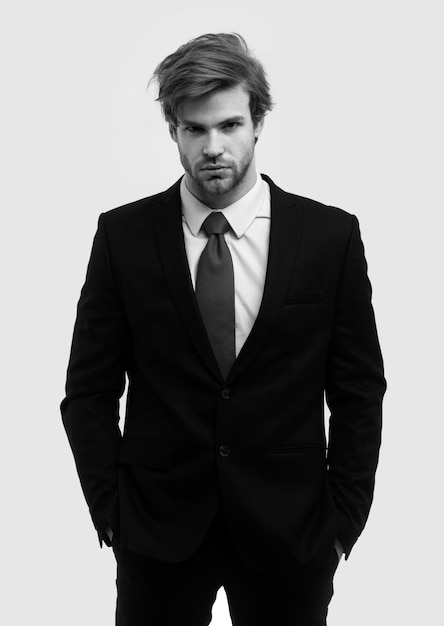 Photo man in formal suit with hands in pockets isolated over white background portrait of serious young