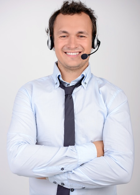 Man in formalwear and headset looking at camera.