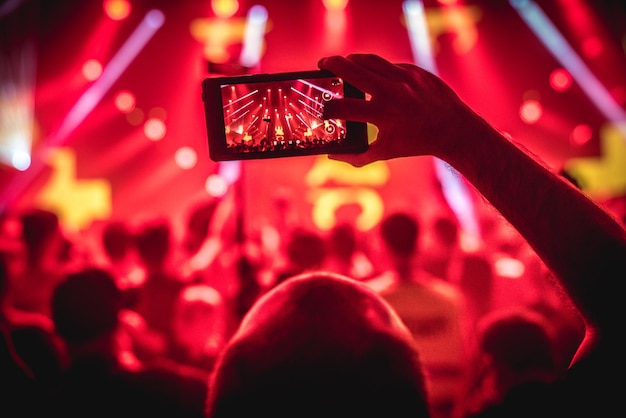 Man fotografeert menigte op een muziekconcert