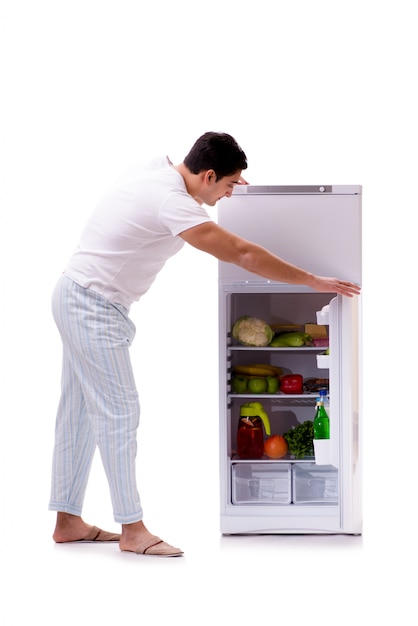 Man next to fridge full of food