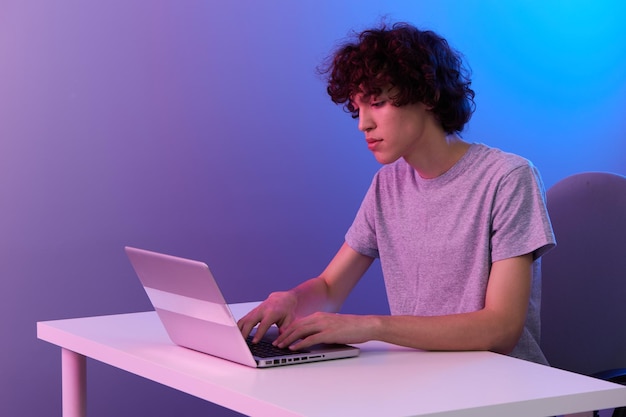 Man in front of laptop entertainment violet background