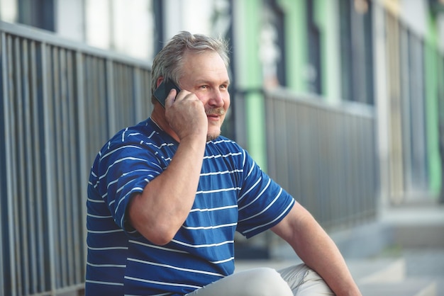 Man fun talking on the phone in the city portrait of a man using devices