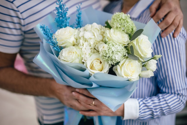 The man gave the woman white flowers