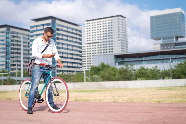 Man gebruikt telefoon terwijl hij op de fiets rijdt in de stad