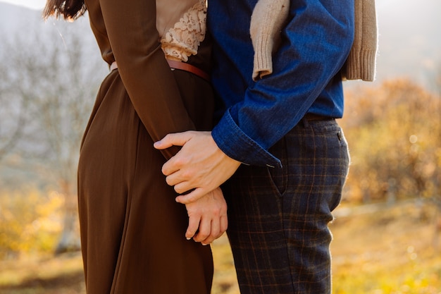 The man gently holds the womans hand