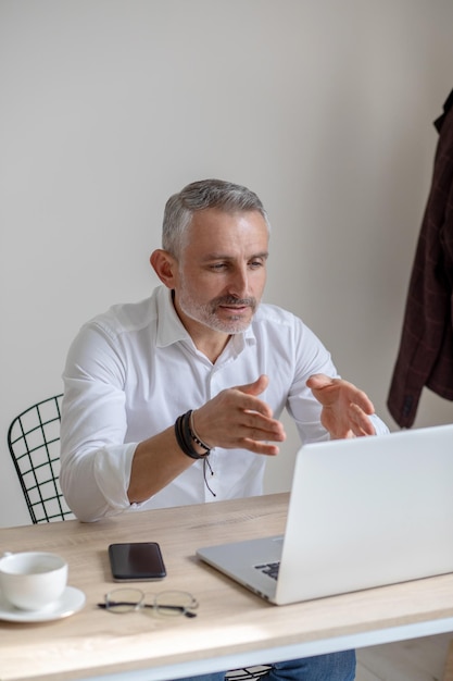 Man gesturing looking at laptop screen